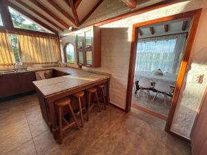 a kitchen with a counter and a table with chairs at Casa RiGi Deluxe in Hacienda El Ingenio