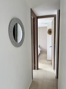 a hallway with a mirror on the wall at Acogedor Refugio Céntrico con Parking Privado in Armenia +9 photos