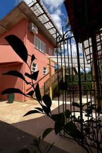 a plant in front of a pink building at Pousada Casa Rosada Ilhabela in Ilhabela