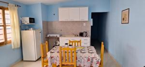 a kitchen with a table with chairs and a refrigerator at Carmelo in San Rafael