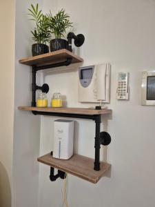 a shelf with a computer and a printer on a wall at Factory 219 Apartment Guidonia in Guidonia