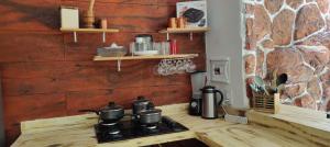 a stove with pots and pans on a counter in a kitchen at Chalés da Cris in Fortim +115 photos