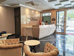 a restaurant with a bar with chairs and a counter at Hotel Damai Kuala Lumpur in Kuala Lumpur