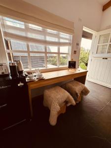 a kitchen with a wooden table and a window at Hotel Boutique El Establo in Puerto Natales +28 photos