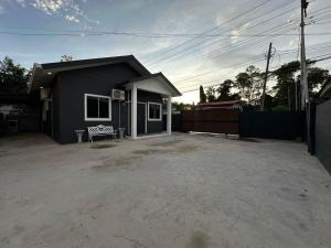 a small house with a large driveway in front of it at SIXTYSIXLUXE 3Br 2B in Penampang