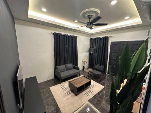a living room with a couch and a table at SIXTYSIXLUXE 3Br 2B in Penampang