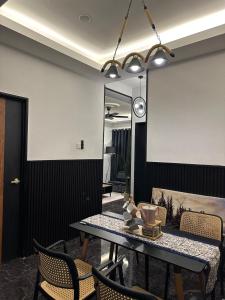 a dining room with a table and chairs at SIXTYSIXLUXE 3Br 2B in Penampang