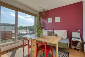 a living room with a table and a window at Naksan Balcony in Seoul