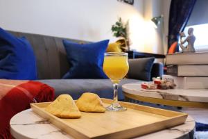 a glass of orange juice and cookies on a tray at Central Costal Getaway in Brighton & Hove