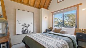 a bedroom with a bed with a picture of a bull on the wall at Westons in Dinner Plain
