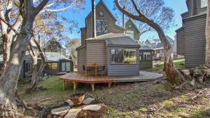 a tiny house on a deck in front of a church at Westons in Dinner Plain