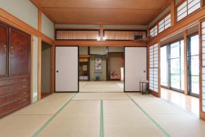 an empty room with doors and windows at GuestHouse道 in Fujiyoshida