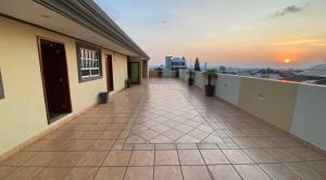 a balcony of a building with a sunset in the background at Hotel Boutique AB in Momoxpan