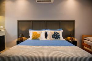 a bedroom with a bed with blue and white sheets and pillows at Studio Brisa da Ferradura - Búzios in Búzios