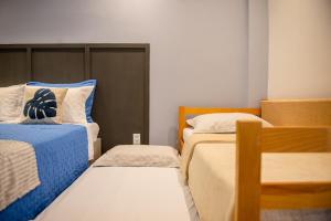 a small room with two beds in a room at Studio Brisa da Ferradura - Búzios in Búzios +41 photos