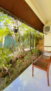 a bench on a porch with a mural of an aquarium at Rach APT in Kerobokan