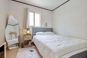 Postel nebo postele na pokoji v ubytování Only Suwon