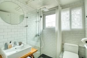 a white bathroom with a sink and a shower at Naksan Balcony in Seoul +84 photos