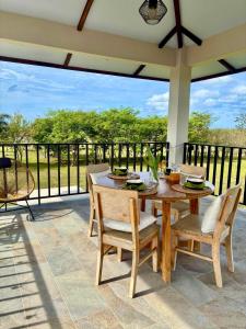 a patio with a wooden table and chairs on a balcony at La Casita 4BR Private Paradise with Pool in La Garita