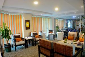 a lobby with chairs and tables and a waiting room at The Beehive in Male City