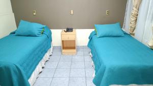 Ein Bett oder Betten in einem Zimmer der Unterkunft Hotel las Dunas