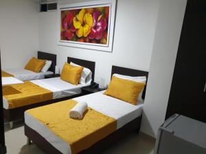 Postel nebo postele na pokoji v ubytování Hotel Girón Plaza