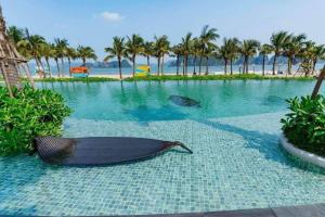 a large swimming pool with a boat on the ground at Rosa Villa - Sonasea - Vân Đồn in Thâm Câu