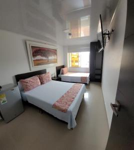 Postel nebo postele na pokoji v ubytování Hotel Girón Plaza
