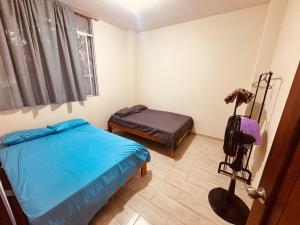 a small bedroom with a bed and a desk at Cri 50 in Tena