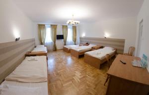 a large room with beds and tables in it at Brama Hostel in Krakow