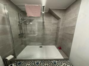 a bathroom with a shower and a bath tub at Apartment in Écommoy near Le Mans Circuit in Écommoy