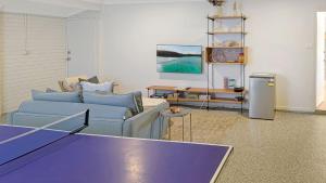 a living room with a ping pong table in it at Collingwood Lodge by Experience Jervis Bay in Vincentia
