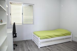 a bedroom with a bed and a desk and a window at Salt Lake view Apartment in Larnaca