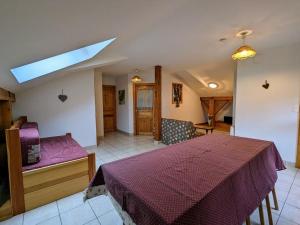 a bedroom with a bed and a couch and a skylight at Gîte du Champ du Bois : Confort au cœur des Vosges - FR-1-589-820 in Le Tholy
