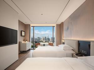 Postel nebo postele na pokoji v ubytování Aden Hotel Shenzhen Nanshan + 37 fotografií