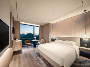 Postel nebo postele na pokoji v ubytování Aden Hotel Shenzhen Nanshan