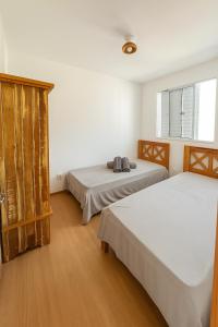 a bedroom with two beds and a window at Apto Prox Parque do Sabia e Aeroporto in Uberlândia +50 photos