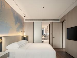 Postel nebo postele na pokoji v ubytování Aden Hotel Shenzhen Nanshan