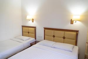 Postel nebo postele na pokoji v ubytování Borneo Suites Hotel + 2 fotografie