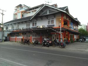 a building with bikes parked in front of it on a street at Kurnia perdana Hotel in Lampung