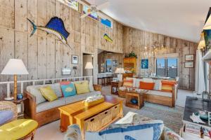 a living room with a couch and a table at 5135 - The Anchor in Croatan Shores