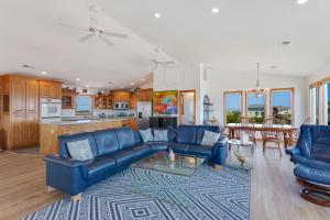 a living room with blue couches and a kitchen at 7088 - Short II in Grun Island