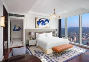 a bedroom with a white bed and a large window at The Lixury Hotel, in The Unbound Collection by Hyatt - Liberation Square in Chongqing