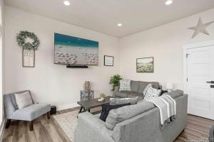 a living room with a couch and a chair at Riverscape Townhome B, Steps to Gruene Hall! in New Braunfels