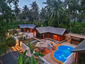 an aerial view of a house with a pool at Casa Di Legno Resort in Salalah