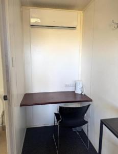 a desk in the corner of a room with a chair at Piangil Cabin and Accomodation in Piangil