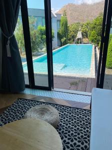 a room with a view of a swimming pool through a window at Adoor hotel Khao Yai in Ban Rai +122 photos