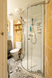 a bathroom with a shower and a toilet at Cosy Haven, 96 Triq il-Karita', Victoria Gozo in Victoria