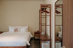 a bedroom with a bed and a wooden bunk ladder at A Stay In CiCi in Ấp An Lộc A +28 photos