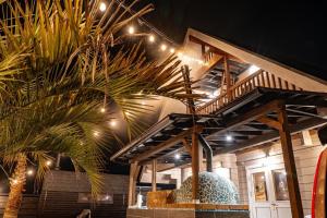 a palm tree in front of a building with lights at M-Style MOTOSUKA in Katakai